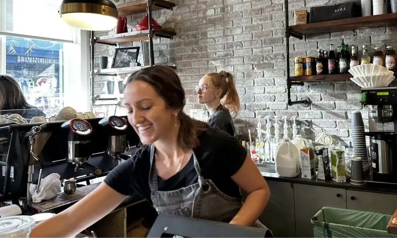 Successful restaurant service, smiling team and seated guests, improved through small business coaching