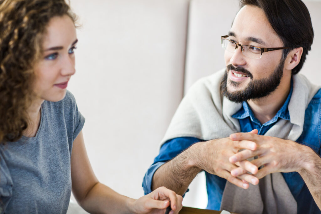 Coach asking powerful questions and encouraging a client to explore new perspectives and insights.