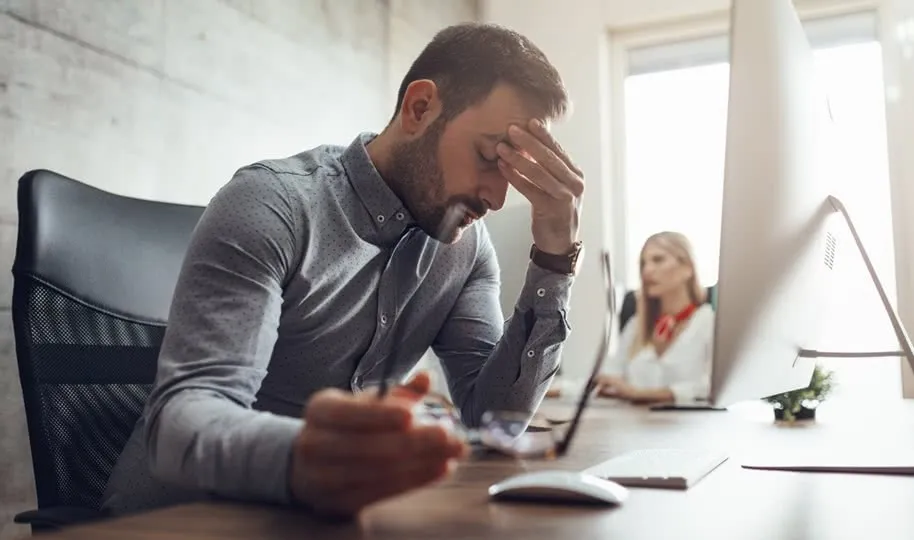 Small business owner deep in thought, reflecting on unspoken assumptions in coaching session