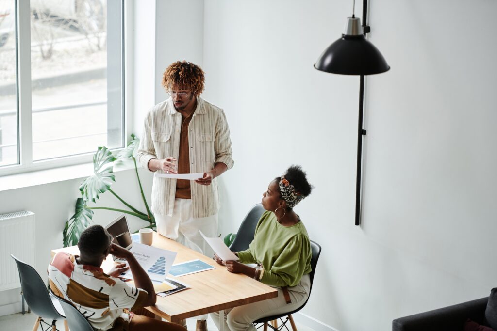 Three small business professionals reviewing a business plan during an economic development coaching conversation