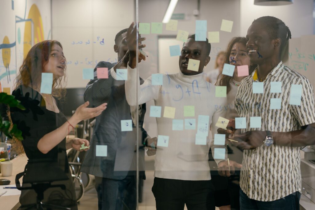 Professionals mapping small business priorities with sticky notes during a coaching session