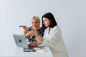 Woman small business owner discussing priorities with a coach during an ICF-aligned coaching conversation
