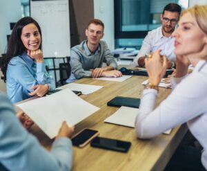 Business colleagues discussing documents around a meeting table